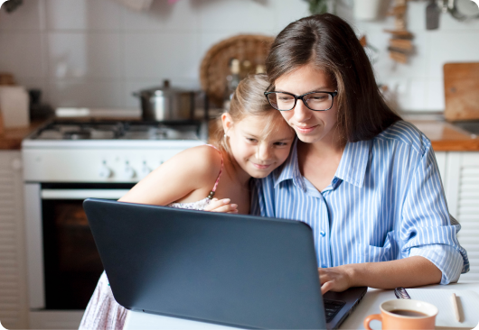 Woman with daughter looking on computer